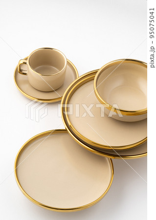 A Set of light brown ceramic plate and cup on a white background A Set of light brown ceramic plate and cup on a white background 95075041