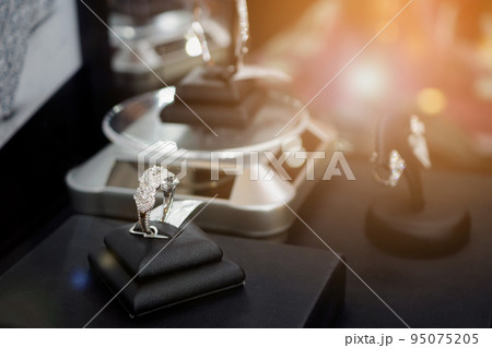 Diamond rings in jewelry luxury store window display Diamond rings in jewelry luxury store window display 95075205