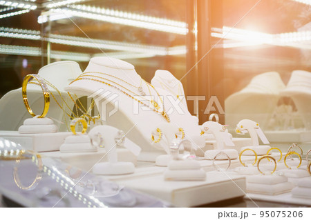 Gold jewelry diamond shop with rings and necklaces luxury retail store window display 95075206