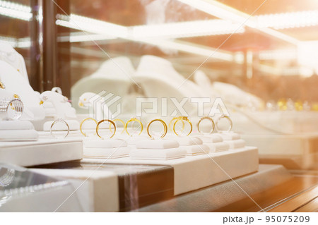 Jewelry diamond rings and necklaces show in luxury retail store window display Jewelry diamond rings and necklaces show in luxury retail store window display 95075209
