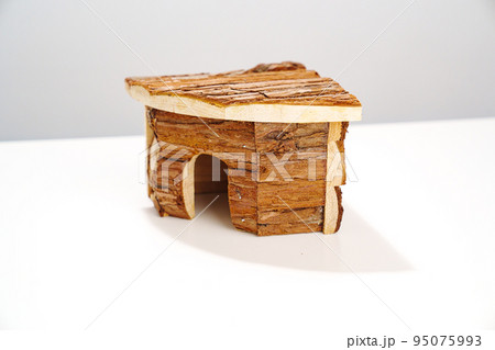 a small wooden house for a hamster and a mouse on a white background.  95075993