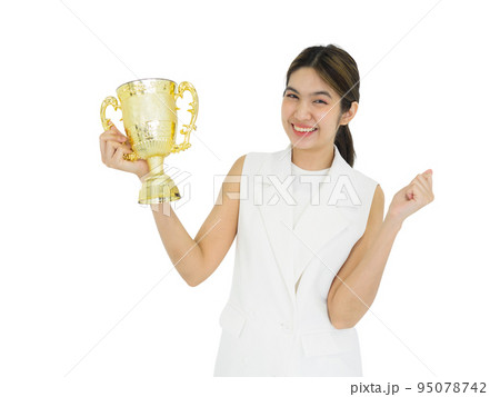 Asian woman in white dress holding the trophy received from the work done proudly. Portrait on white background with studio light. Asian woman in white dress holding the trophy received from the work done proudly. Portrait on white background with studio light. 95078742