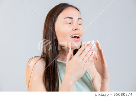 Young woman sneezes. Allergy, cold, virus Young woman sneezes. Allergy, cold, virus 95080274