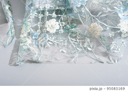 details of glamour shiny lace dress with sequins and hand made embroidery. floral ornament on wedding or party dress. details of glamour shiny lace dress with sequins and hand made embroidery. floral ornament on wedding or party dress. 95083169