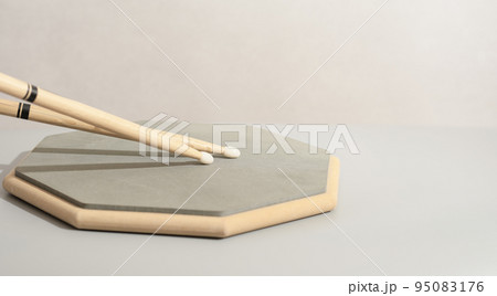 Pair of drumsticks, training pad, practicing for drummers. Copy paste. Music learning concept Pair of drumsticks, training pad, practicing for drummers. Copy paste. Music learning concept 95083176