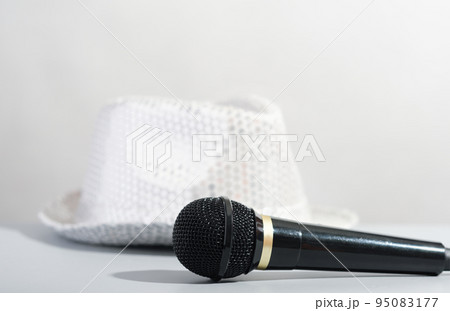 A glittery silver sequin party hat and microphone. Bright paillette hat and presenter microphone. show host accessories. 95083177