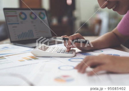 Business woman hand using calculator to calculate the company's financial results and budget. Account Audit Concept 95085402