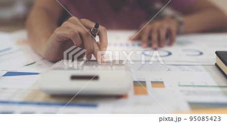 Business woman hand using calculator to calculate the company's financial results and budget. Account Audit Concept 95085423