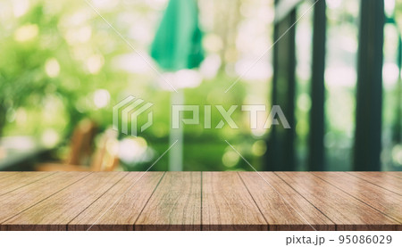 Empty wooden table top with lights bokeh on blur restaurant background. 95086029