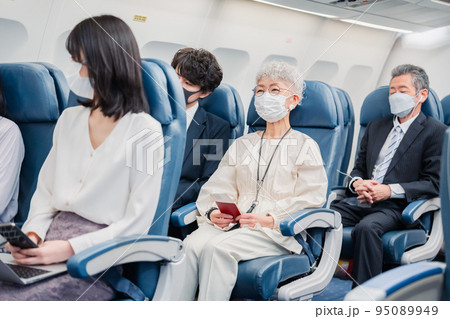 飛行機の機内で過ごす乗客 95089949