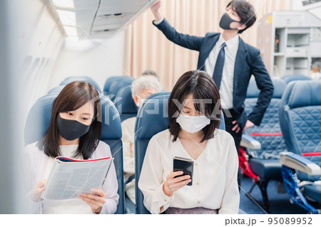 飛行機の機内で過ごす乗客 飛行機の機内で過ごす乗客 95089952