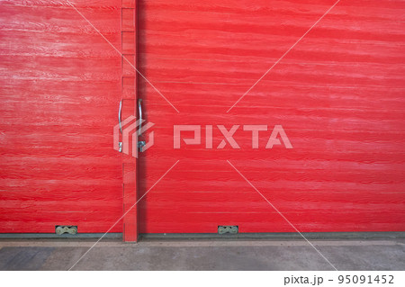 Metal lock and door handle on the red wooden door. Abstract red wood planks background wall texture. Wooden texture red colour for backdrop. Red texture of pine wood grain panel with copy space. Metal lock and door handle on the red wooden door. Abstract red wood planks background wall texture. Wooden texture red colour for backdrop. Red texture of pine wood grain panel with copy space. 95091452