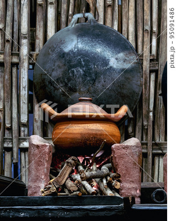 Variety and types of utensils for simple cooking of Asian families in the past. Traditional Asia and Thai old kitchen style interior. Antique kitchen with utensils at bamboo cottage. Selective focus. Variety and types of utensils for simple cooking of Asian families in the past. Traditional Asia and Thai old kitchen style interior. Antique kitchen with utensils at bamboo cottage. Selective focus. 95091486