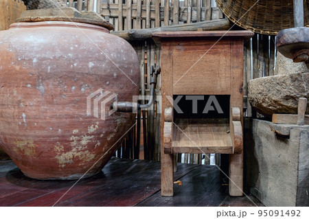 Variety and types of utensils for simple cooking of Asian families in the past. Traditional Asia and Thai old kitchen style interior. Antique kitchen with utensils at bamboo cottage. Selective focus. 95091492