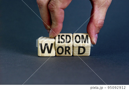 Wisdom word symbol. Concept words Wisdom word on wooden cubes. Businessman hand. Beautiful grey table grey background. Business and wisdom word concept. Copy space. 95092912