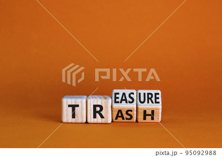 Trash to treasure symbol. Businessman turned cubes and changed the word trash to treasure. Beautiful orange table, orange background. Business, trash to treasure concept. Copy space. 95092988