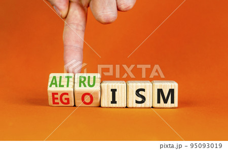 Altruism or egoism symbol. Concept words Egoism and Altruism on wooden cubes. Psychologist hand. Beautiful orange table orange background. Business psychological altruism or egoism concept. Copy space 95093019