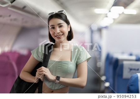 Backpacker asian woman in the airplane while to destination. Travel concept Backpacker asian woman in the airplane while to destination. Travel concept 95094253
