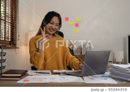 Asian Accountant video call with client by laptop. work from home concept Asian Accountant video call with client by laptop. work from home concept 95094359