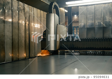 heavy industrial laser cutting machine during massive metal sheet processing 95094631