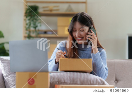 Asian SME business woman talking with client by phone at home office. online shopping concept Asian SME business woman talking with client by phone at home office. online shopping concept 95094669