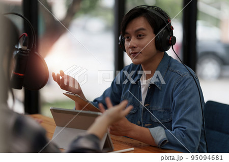 Podcaster making audio podcast working with guest at home studio 95094681
