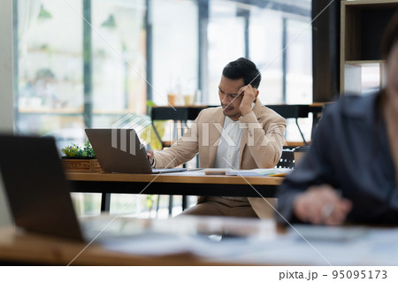 Stressed Asian businesswoman analyzes financial charts. Account and audit concept 95095173