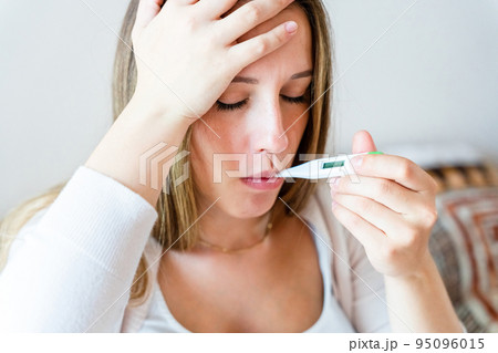 Pregnant sick fever thermometer. Pregnancy woman holding thermometer, check fever flu temperature. Pregnant girl sick. Pregnancy, medicine health care concept. Pregnant sick fever thermometer. Pregnancy woman holding thermometer, check fever flu temperature. Pregnant girl sick. Pregnancy, medicine health care concept. 95096015