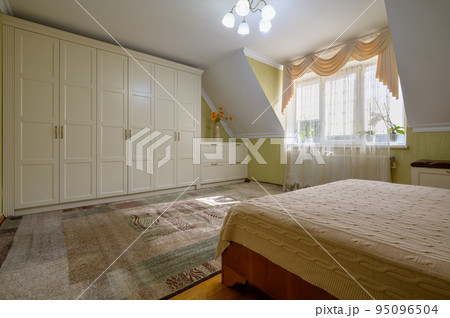 Interior of a large comfortable bedroom with double bed Interior of a large comfortable bedroom with double bed 95096504
