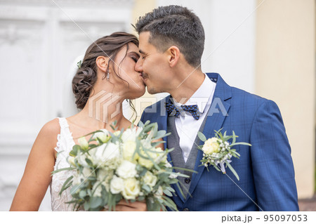 Newlywed husband and wife are kissing their first kiss on their special day 95097053
