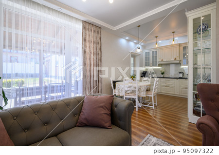 Studio apartment with living room and white large kitchen, dining table Studio apartment with living room and white large kitchen, dining table 95097322