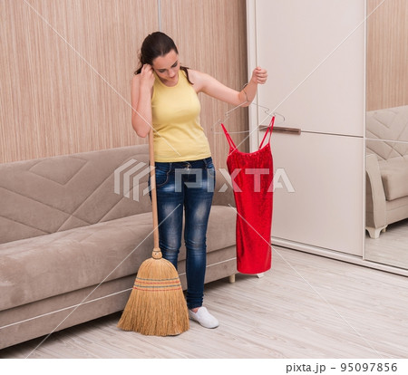 Young woman doing cleaning at home Young woman doing cleaning at home 95097856