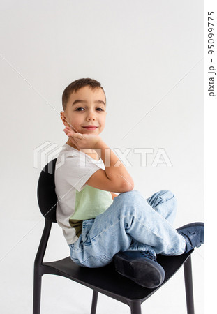 Boy child preschooler smiling and posing on gray background in photo studio 95099775