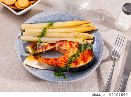 Grilled salmon steak with asparagus and pesto Grilled salmon steak with asparagus and pesto 95101840