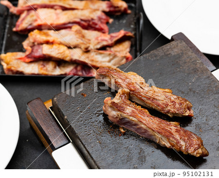 Process of meat cooking on grilling stone Process of meat cooking on grilling stone 95102131