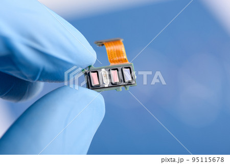 Scientist hold in fingers fitness tracker smart watch component with different sensor array Scientist hold in fingers fitness tracker smart watch component with different sensor array 95115678