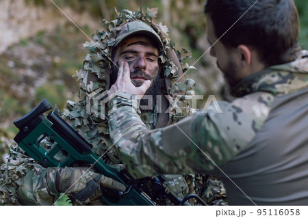special operations soldiers team preparing tactical and communication gear for action battle. Long distance sniper team in checking gear for action 95116058