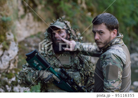 special operations soldiers team preparing tactical and communication gear for action battle. Long distance sniper team in checking gear for action 95116355