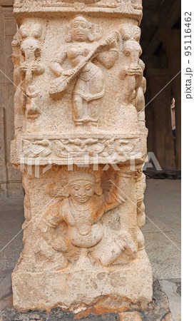 Sculpture of Goddess Sarshwati holding a harp and demons at bottom of pillar, at Shesharayar Mandapam, Sri Ranganathaswamy Temple, Srirangam, Trichy, Tamil Nadu, India Sculpture of Goddess Sarshwati holding a harp and demons at bottom of pillar, at Shesharayar Mandapam, Sri Ranganathaswamy Temple, Srirangam, Trichy, Tamil Nadu, India 95116462