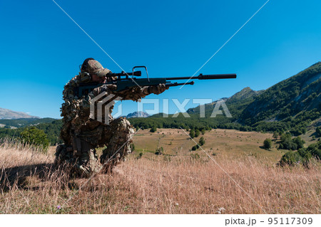 army soldier holding sniper rifle with scope and aiming in forest. war, army, technology and people concept 95117309
