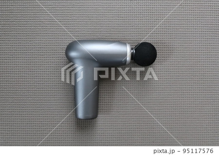 A massage gun for athlete with a ball head without the brand name A massage gun for athlete with a ball head without the brand name 95117576
