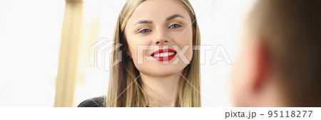 Beautiful woman hairdresser smiles at a guy, close-up 95118277