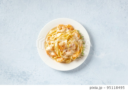 Seafood pasta. Pappardelle with shrimps and cream sauce in a white plate 95118495