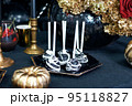Dessert table for Halloween. Themed cake pops. Golden pumpkin and golden flowers decoration 95118827