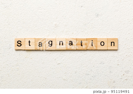 stagnation word written on wood block. stagnation text on cement table for your desing, concept 95119491