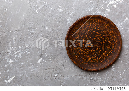 Top view of empty plate on cement background. Empty space for your design 95119563