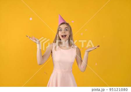 Concept of Happy Birthday, young woman on yellow background 95121080