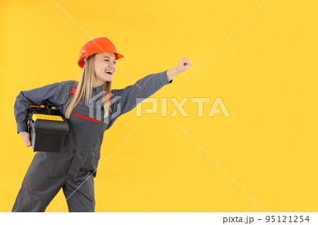 Concept of occupation, young woman on yellow background Concept of occupation, young woman on yellow background 95121254