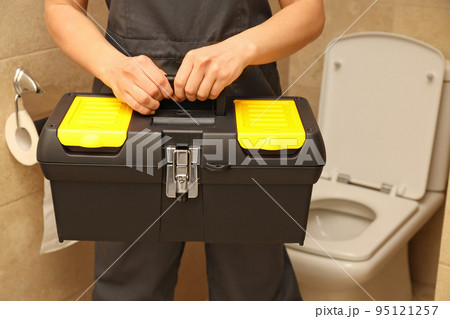 Concept of occupation, young woman plumber with tools box Concept of occupation, young woman plumber with tools box 95121257