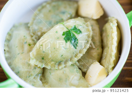 Boiled dumplings with stuffing inside, from dough with herbs Boiled dumplings with stuffing inside, from dough with herbs 95121425